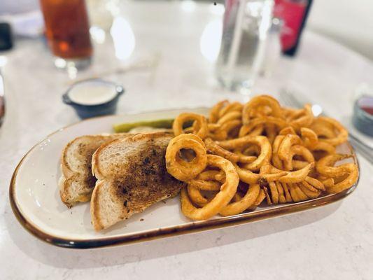 Buffalo Grilled Chicken Sandwich with curly fries.