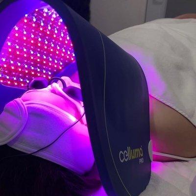 Client with Celluma LED treatment during a facial service.