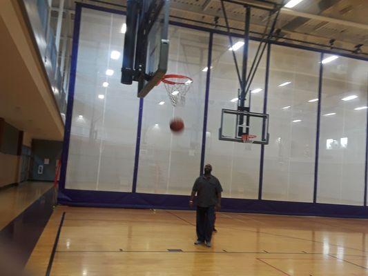So many amenities indoor gym with several basketball hoops.