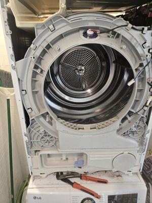 Opened LG washing machine mid-repair to access and replace faulty drain pump and lid switch.