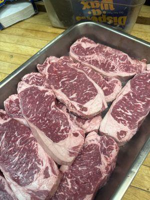 Look at the beautiful marbling on these New York steaks