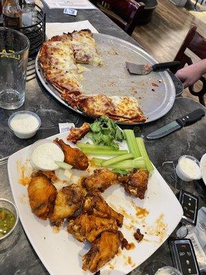 40 wings and an awesome pizza. Would have take. It home but flying home.