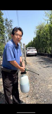 Kong spraying poison around his five acres.