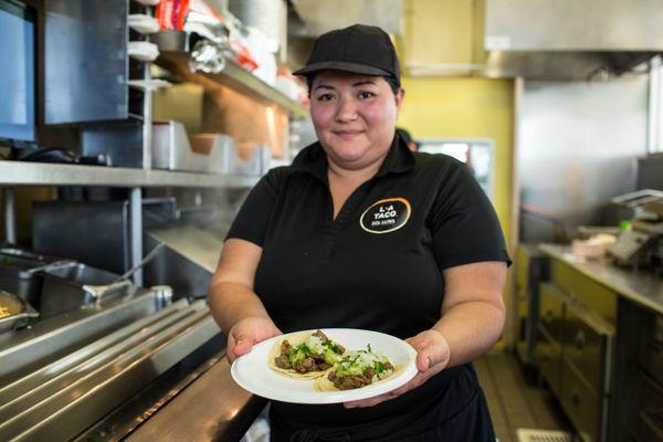Karen Offering a Delicious Plate of Carne Asada Soft Tacos