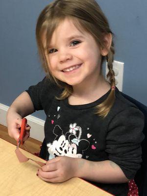 Working on fine motor skills.  Even toddlers learn how to use scissors at La Petite Ecole!
