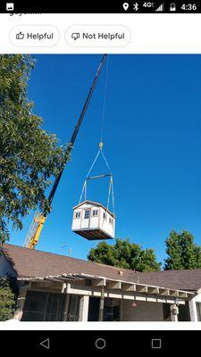 Our shed being lifted over our house.