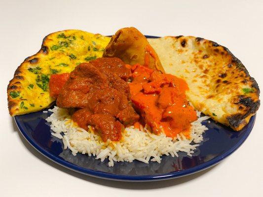 Lamb Vindaloo, Chicken Makhni, Garlic Naan, Goat Cheese Naan, Veggie Samosas, and Rice.