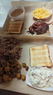 Grilled onion hamburger steak with macaroni and white beans, pork plate with fried okra and potato salad, both with Texas toast.