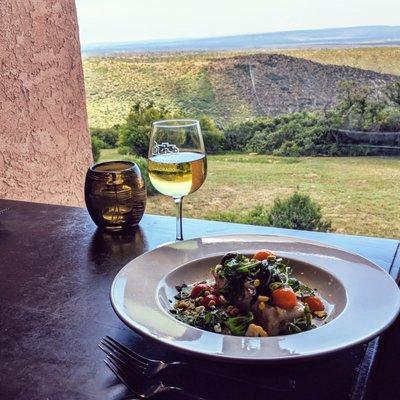 Seared salmon with Creamy Green Chile Rice, Heirloom Tomato Salad, Charred Corn Coulis, Cilantro Oil
