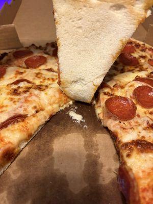 Raw undercooked pepperoni pizza