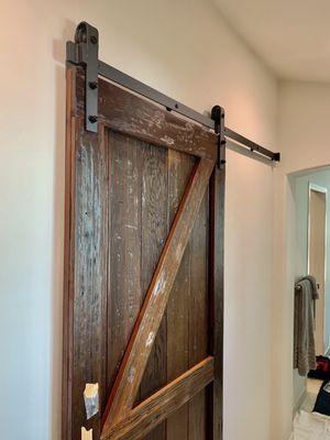 Distressed door with matte black barn style door hardware