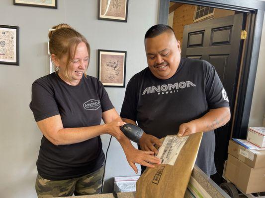 Jose, right, and Jessi log in a package for shipment.