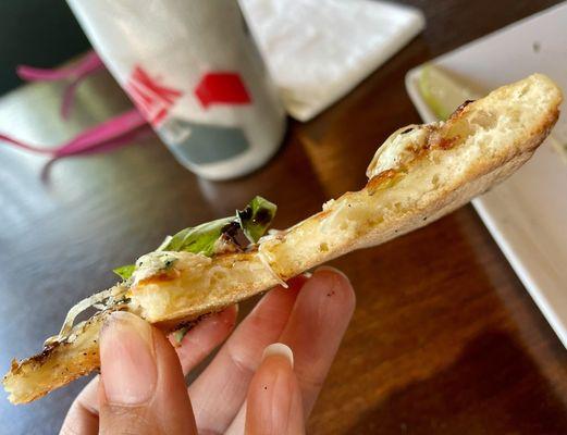 Cross-section of the thin, crunchy, not floppy crust.