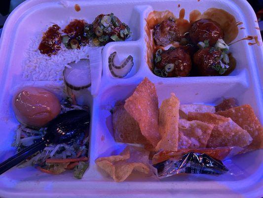 Large bento box: rice, meatballs in teriyaki sauce, wonton crispies, slaw with pickled egg, and radish/cuke pickles in the middle.