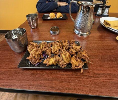 Onion Bhaji and Vegetable Samosa and Tamarind Sauce and Mint Chutney.