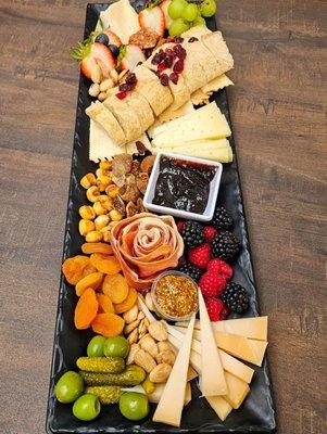 Goldilocks Cheese Board: triple cream brie, swiss, and gouda with various accouterments.