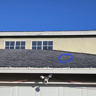 Missing shingles blown off by the rain storms. Possible slow leak over the garage.