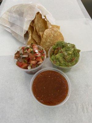 Homemade chips shown with Salsa Fresca, our hot sauce and fresh guacamole
