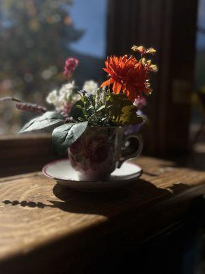Fresh flowers in a tea cup