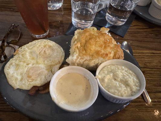 Fried eggs, crispy bacon, grits, gravy and biscuit