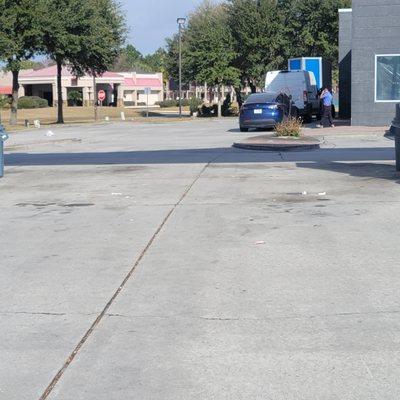 Trash, bag flying away in the background, trash by the pump stations