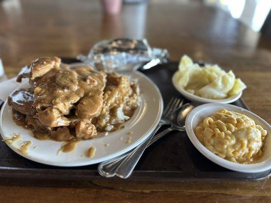 Smothered Pork Chop with Mac & Cheese, cabbage, corn bread and cake.