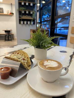 Flat white and breakfast taco with bacon