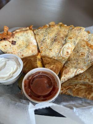 Quesadilla with bacon, onion,avocado and tomato. Served with sour cream and salsa. My second time ordering it. It's delicious!