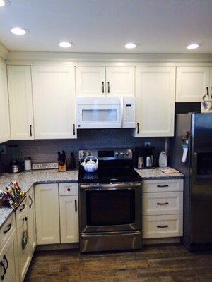 This condo kitchen was completely remodeled. There are wood look porcelain Floors new painted Cabinetry .