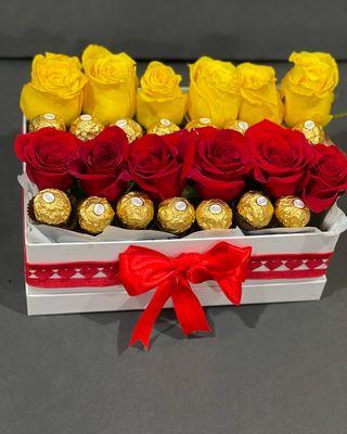 "A box full of love and luxury! Bright yellow and deep red roses meet golden FR chocolates, beautifully arrangement