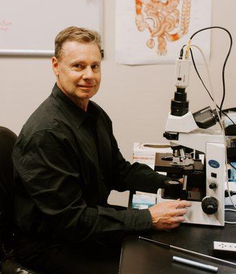 Dr. Thomas Brewer at his microscope