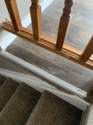 unswept flooring under railing