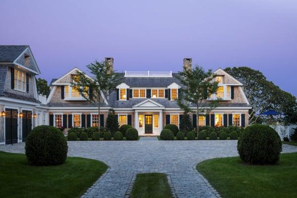 A quintessential shingle-style gambrel cottage on the coast of New England.
