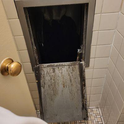 Trash chute door WIDE open. This looks perfectly safe...said no one.