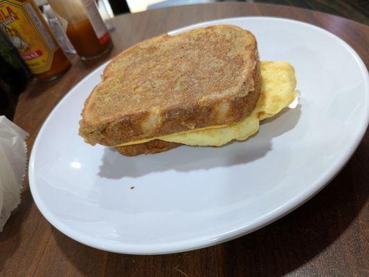 French toast sandwich with omelette and sausage