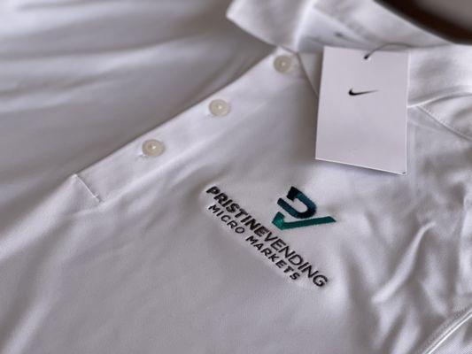 Pristine Vending embroidery on white Nike polos.