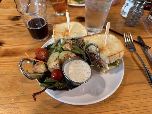 Chicken salad sandwich with a side salad.
