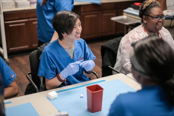 A student in one of CCI's medical/healthcare programs talks with other students in the course.