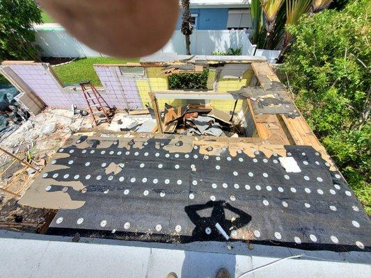 Flat roof demo for walls to be raised 4 foot in height and new trusses for ceiling to be 12' finish