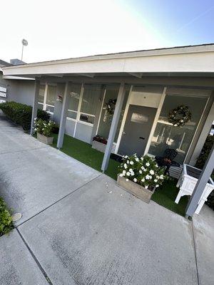 Outdoor waiting area, complete with bistro seating for three.