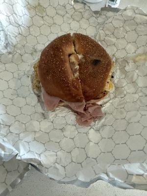 Untouched ham and egg bagel getting to disappear!
