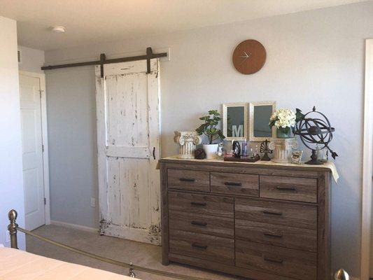 Distressed barn Door in a master bedroom into the ensuite