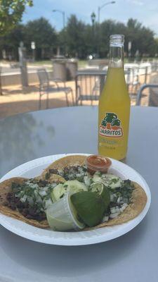 Asada tacos on corn tortilla with cilantro and onions.
