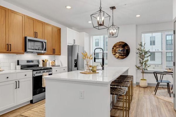 Open kitchen with a large white island with a countertop