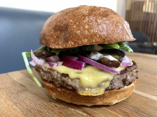 Impossible patty, vegan provolone, sauteed garlic thyme mushrooms, roasted garlic aioli, red onion & spinach on a grand central bakery bun