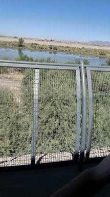 Over the fence is a 25-30 ft drop to the river bottom.