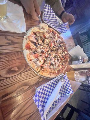 A Large All Meat Pizza with additional olives & mushrooms.