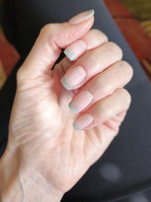 Dip nails with silver glitter French tip.