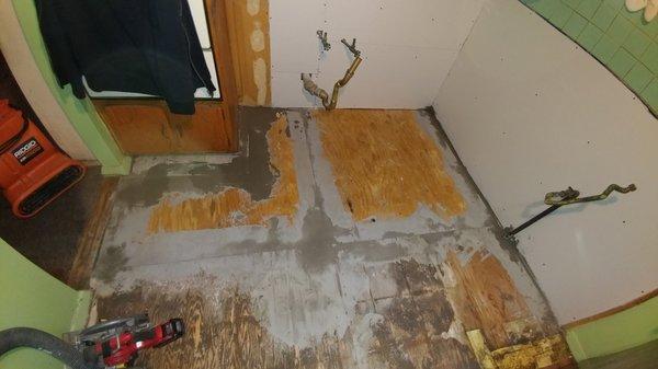 floor repaired with plywood and leveled flush with existing sub floor. floor patch was used to fill in the seems to prep for vinyl tile