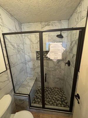 Semi-frameless shower enclosure.